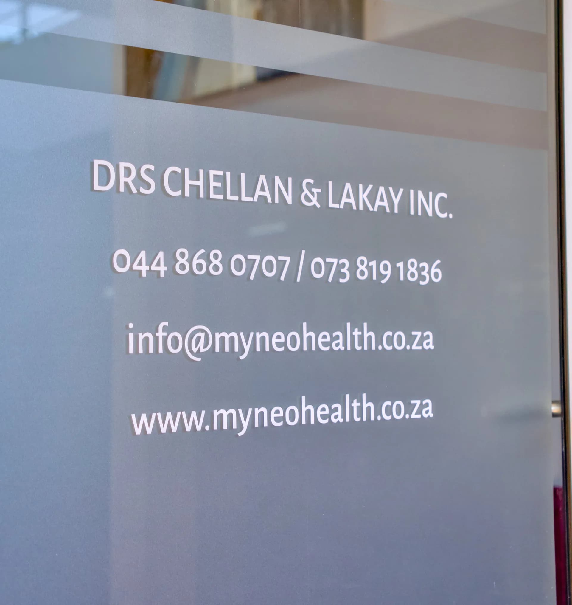 Entrance: glass door with practice details.