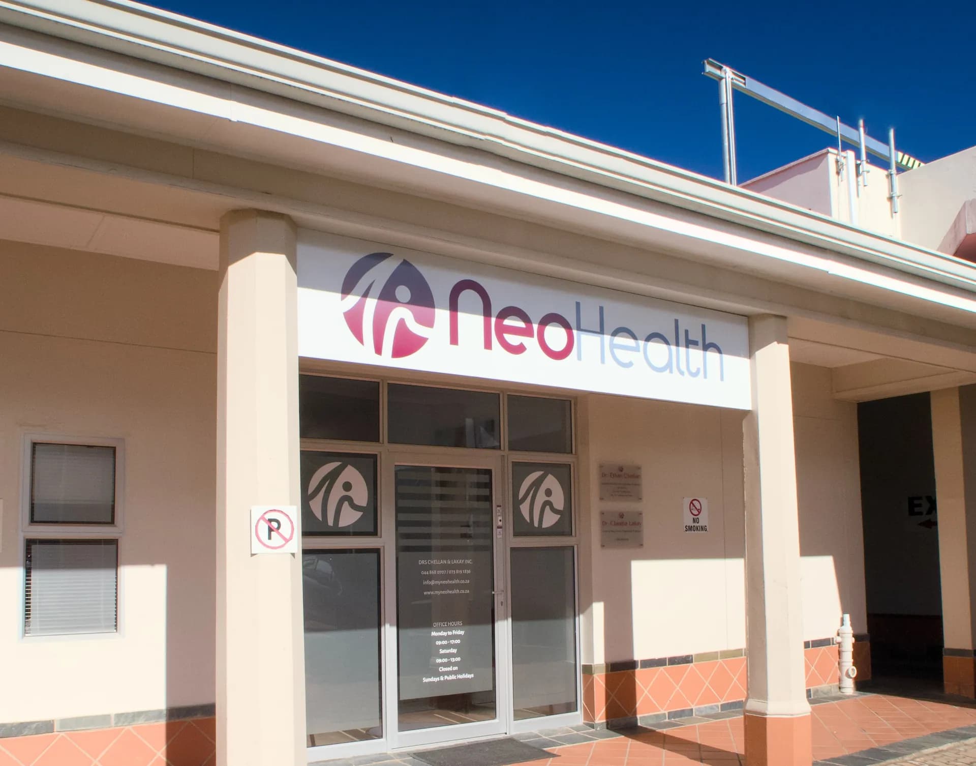 Exterior with NeoHealth signage, warm afternoon light.